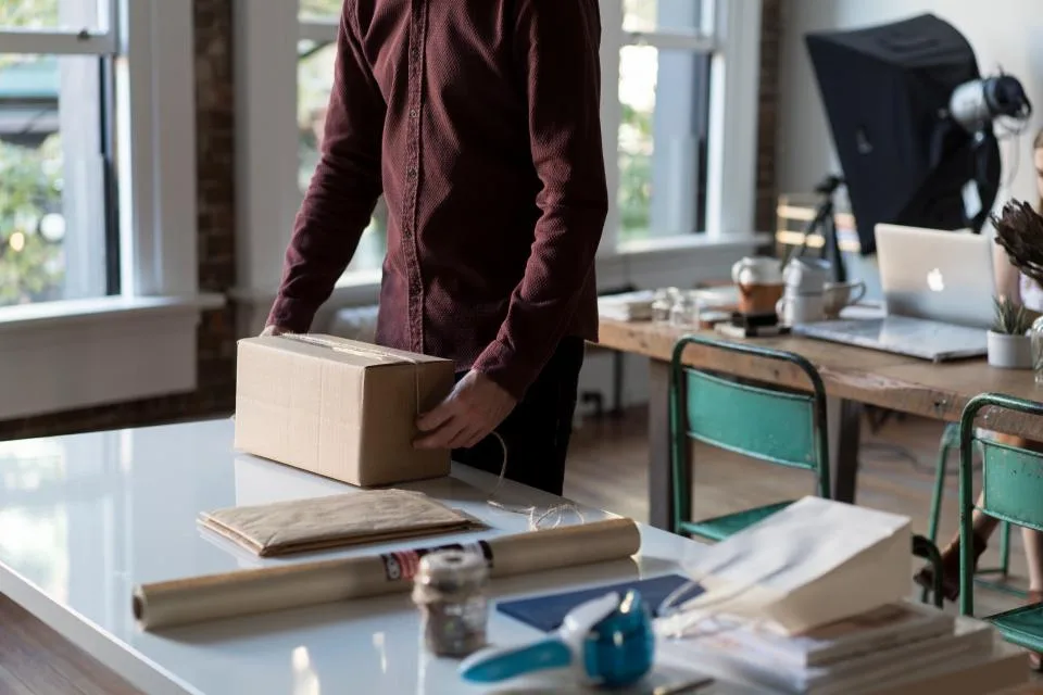 Packing a cardboard box in an office