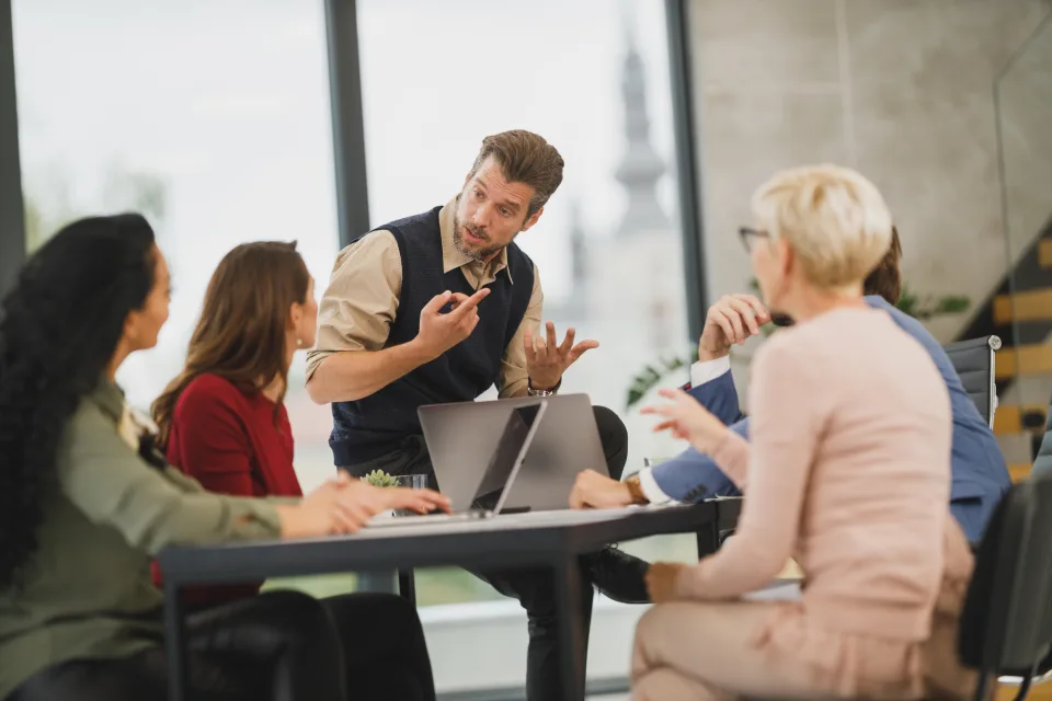 A team talking through a plan around a meeting table